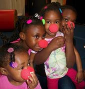 Kids with clown noses at a birthday party